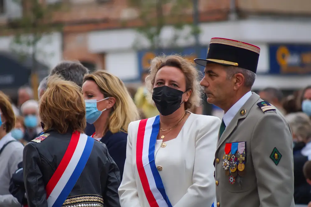 Officier en uniforme avec médailles et galons militaires de grade lors d'une cérémonie officielle.