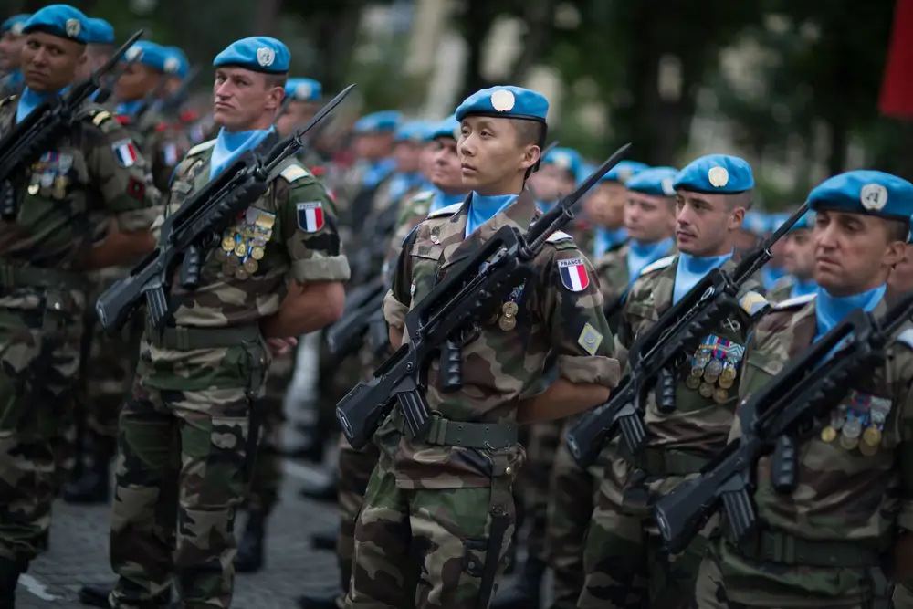 Légionnaires en tenue de combat et bérets bleus lors d'une cérémonie militaire d'un régiment de l'armée de Terre.
